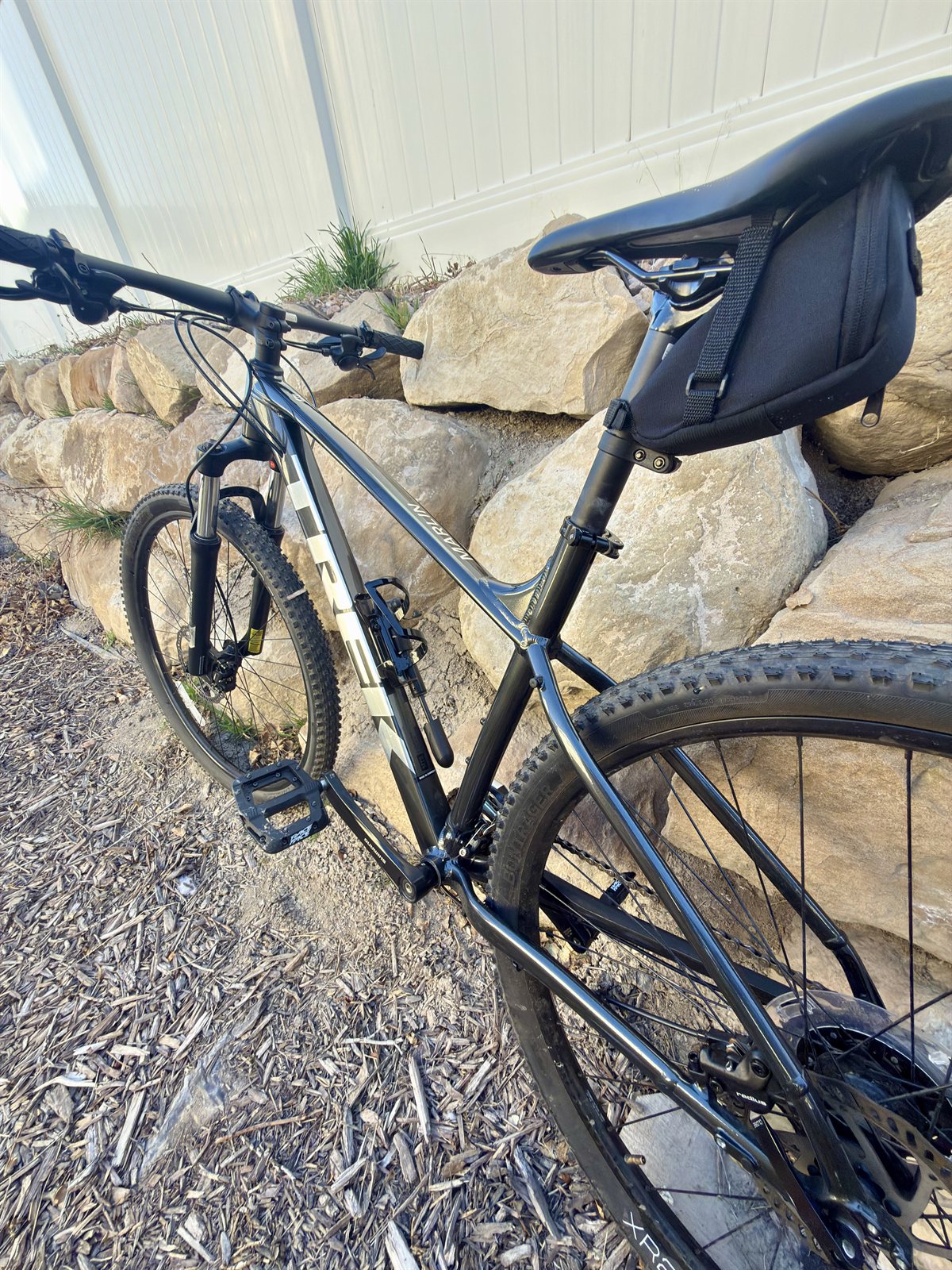 Trek mountain bike photographed outdoors against a rock wall